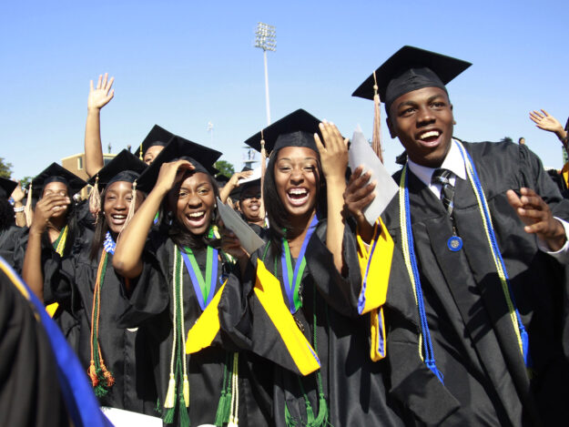 Students react during the graduation ceremony of the 2010 class at Hampton University in Virginia May 9, 2010. U.S. President Barack Obama delivered the commencement address at the graduation and was conferred an honorary doctor of laws degree.     REUTERS/Jason Reed   (UNITED STATES - Tags: POLITICS EDUCATION IMAGES OF THE DAY) - RTR2DNV8